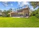 Expansive backyard features a screened-in pool area, outdoor dining, and a lush green lawn at 11817 Glen Wessex Ct, Tampa, FL 33626