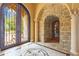 Elegant foyer with marble floors, decorative columns, stone archway and wrought iron doors at 11817 Glen Wessex Ct, Tampa, FL 33626