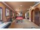 This cozy game room features a pool table, bar seating, and unique arched wooden door at 11817 Glen Wessex Ct, Tampa, FL 33626