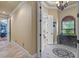 Hallway featuring an arched window, tile floors, and view into a bathroom at 11817 Glen Wessex Ct, Tampa, FL 33626