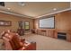Spacious home theater room has comfortable seating and a large projection screen at 11817 Glen Wessex Ct, Tampa, FL 33626