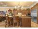 Stylish kitchen showcasing wood cabinets, granite counters, stainless steel appliances, and a large island at 11817 Glen Wessex Ct, Tampa, FL 33626
