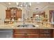 Spacious kitchen counter with stainless steel sink and view of the bar and sitting area at 11817 Glen Wessex Ct, Tampa, FL 33626