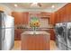 Open concept kitchen with stainless steel appliances, a center island, and ample cabinet space at 11817 Glen Wessex Ct, Tampa, FL 33626