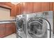 Laundry room with stainless steel washer and dryer, and a granite countertop at 11817 Glen Wessex Ct, Tampa, FL 33626