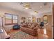 Living room featuring a leather couch, area rug, shutters, and an office space at 11817 Glen Wessex Ct, Tampa, FL 33626