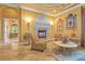 Bright living room featuring elegant fireplace, marble floors, decorative trim and wall sconces, plus comfortable seating area at 11817 Glen Wessex Ct, Tampa, FL 33626