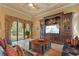 Living room with pool views, custom entertainment center, and comfortable seating at 11817 Glen Wessex Ct, Tampa, FL 33626