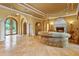 Expansive living room with stone floors, arched doorways, fireplace, and large windows showcases natural light and elegant design at 11817 Glen Wessex Ct, Tampa, FL 33626