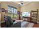 Relaxing living room with a recliner, TV, and serene lake view, creating a cozy and inviting space at 11817 Glen Wessex Ct, Tampa, FL 33626