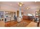 Open-concept living room with ceiling fans, wood floors, built-in shelving, and a comfortable leather couch at 11817 Glen Wessex Ct, Tampa, FL 33626