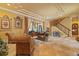 Elegant living room with stone floors, staircase, ornate furnishings, and large windows showcases natural light and elegant design at 11817 Glen Wessex Ct, Tampa, FL 33626