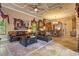 Comfortable living room with large leather sofas open to kitchen and breakfast bar with travertine flooring at 11817 Glen Wessex Ct, Tampa, FL 33626
