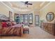 Spacious main bedroom featuring tray ceilings, plantation shutters, and warm neutral colors at 11817 Glen Wessex Ct, Tampa, FL 33626
