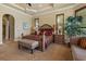 Comfortable main bedroom with a tray ceiling, plenty of natural light, and elegant decor at 11817 Glen Wessex Ct, Tampa, FL 33626