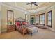 Serene main bedroom with large windows, and a tray ceiling with recessed lighting at 11817 Glen Wessex Ct, Tampa, FL 33626