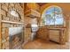 Well-equipped outdoor kitchen featuring stainless steel appliances and custom stone design with a view at 11817 Glen Wessex Ct, Tampa, FL 33626