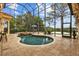 A luxury backyard pool with a spa, patio furniture, and scenic views of the water at 11817 Glen Wessex Ct, Tampa, FL 33626