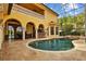 Stunning view of the pool and spa with outdoor kitchen and screened enclosure at 11817 Glen Wessex Ct, Tampa, FL 33626