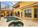 A beautiful pool and spa in a luxury outdoor living area with columns and covered seating, showcasing quality construction at 11817 Glen Wessex Ct, Tampa, FL 33626
