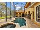 Exterior view of a screened pool and patio, showcasing outdoor living spaces, landscaping and serene waterfront views at 11817 Glen Wessex Ct, Tampa, FL 33626