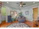 Comfortable sitting room with hardwood floors, a leafy plant, cozy armchair, and neutral colored walls at 11817 Glen Wessex Ct, Tampa, FL 33626