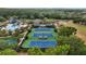 Community tennis courts featuring professional surfacing, with lush landscaping and a shaded seating area at 11817 Glen Wessex Ct, Tampa, FL 33626