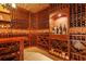 Well-stocked wine cellar featuring custom wood racking, brick ceiling, stone tile and recessed lighting at 11817 Glen Wessex Ct, Tampa, FL 33626