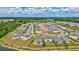 Community aerial shot features well-maintained homes, manicured lawns, and serene surroundings, emphasizing neighborhood charm at 12710 Hysmith Loop, Parrish, FL 34219
