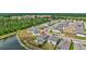 Aerial view of a neighborhood with manicured lawns and a pond nearby at 12710 Hysmith Loop, Parrish, FL 34219