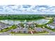 Beautiful aerial view of a community pool, clubhouse, parking lot, and nearby lake at 12710 Hysmith Loop, Parrish, FL 34219