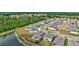 Aerial shot showcasing modern homes in a community adjacent to lush greenery and a tranquil lake at 12710 Hysmith Loop, Parrish, FL 34219