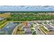 The aerial image displays the home's location, fenced yard, near lake, and community, set against lush landscapes at 12710 Hysmith Loop, Parrish, FL 34219