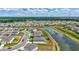 Aerial view showcasing community homes nestled around a tranquil pond setting at 12710 Hysmith Loop, Parrish, FL 34219