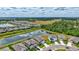 Overhead scene captures community homes nestled by lake and greenery, highlighting neighborhood's picturesque location at 12710 Hysmith Loop, Parrish, FL 34219