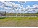 Expansive backyard with green lawn, pond view, and black wrought iron fence providing both privacy and a scenic backdrop at 12710 Hysmith Loop, Parrish, FL 34219