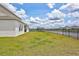Lush backyard with a view of the pond and black wrought iron fence showcasing an outdoor living at its finest at 12710 Hysmith Loop, Parrish, FL 34219