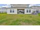 This home boasts a covered patio with furniture and ample lawn space, ideal for entertaining and relaxation at 12710 Hysmith Loop, Parrish, FL 34219