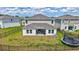 This well-maintained backyard features a covered patio, a full fence, and green grass, perfect for outdoor activities at 12710 Hysmith Loop, Parrish, FL 34219