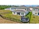 Aerial view of a fenced backyard with a covered patio, a grill and lush lawn at 12710 Hysmith Loop, Parrish, FL 34219