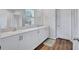 Bathroom with double sinks, granite countertops and white cabinets at 12710 Hysmith Loop, Parrish, FL 34219