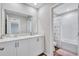 Bright bathroom featuring double sinks, white cabinets, and a shower-tub combo at 12710 Hysmith Loop, Parrish, FL 34219