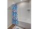 Bathroom featuring a tub-shower with a tiled wall and a colorful shower curtain at 12710 Hysmith Loop, Parrish, FL 34219