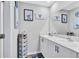 Bathroom featuring double sinks, white cabinets, and 'Lilo and Stitch' decor at 12710 Hysmith Loop, Parrish, FL 34219