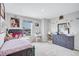Charming bedroom with natural light, neutral carpet, featuring a full-sized bed, vanity and dresser for a tranquil space at 12710 Hysmith Loop, Parrish, FL 34219