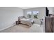 Well-lit bedroom featuring two windows, neutral carpet, and furnishings including a full-sized bed, dresser and desk at 12710 Hysmith Loop, Parrish, FL 34219
