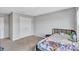 Cozy bedroom with neutral carpet, a full-sized bed and a double-door closet providing ample storage space at 12710 Hysmith Loop, Parrish, FL 34219