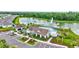 Community clubhouse features refreshing pool, serene pond view, and cozy lounge chairs, perfect for relaxation at 12710 Hysmith Loop, Parrish, FL 34219