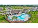 Community pool featuring a unique shape, many chairs for lounging, and an outdoor covered pavilion at 12710 Hysmith Loop, Parrish, FL 34219