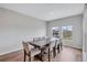 Inviting dining room with views of a pond, features a modern table and chairs at 12710 Hysmith Loop, Parrish, FL 34219